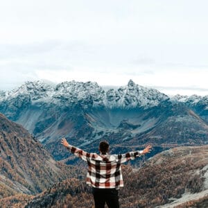 Exploring Prayers from the Old Testament Man in prayer with outstretched arms toward a beautiful snow covered mountain range